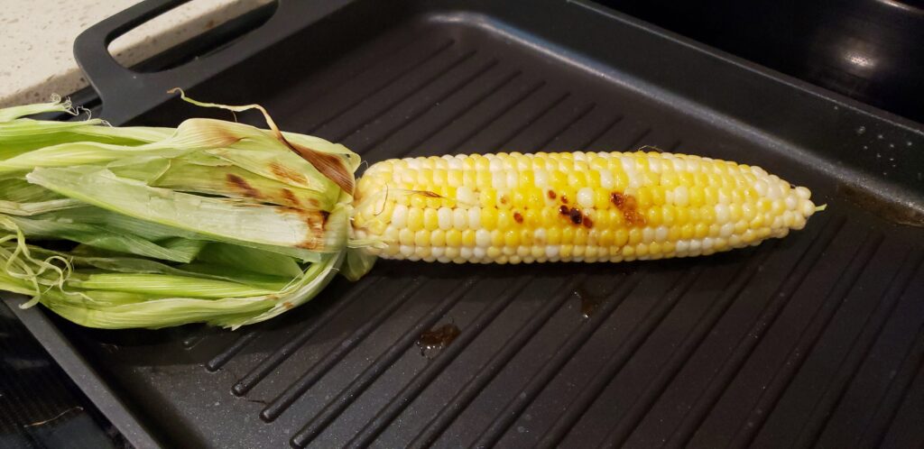 corn grilling on a pan