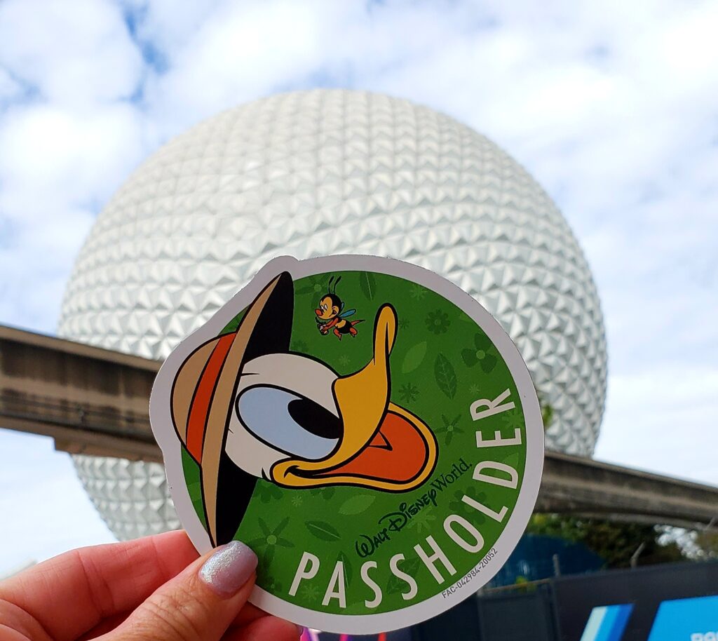 epcot ball with donald duck magnet being held in womans hand