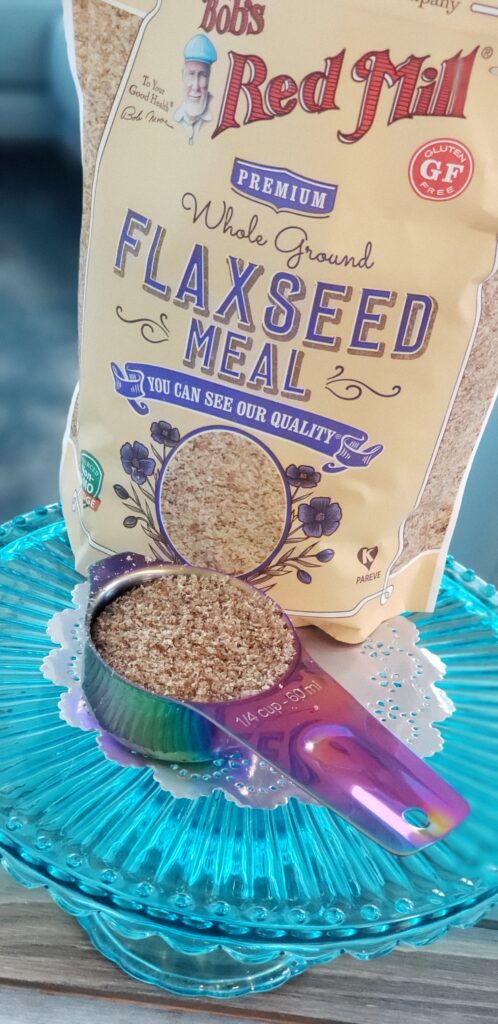 flax seeds bag filled with a spoon of flaxseed in front