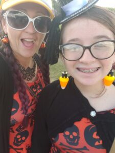 mom and daughter with orange punkin dressed on and candy corn earings