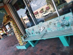 juice n java cafe cocoa beach florida - more art on the side walk - bench