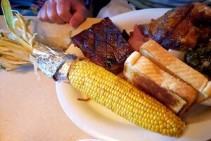 plate with bbq food - corn on the cob - ribs - texas toast and beef