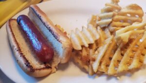 hot dog with french fries on a plate
