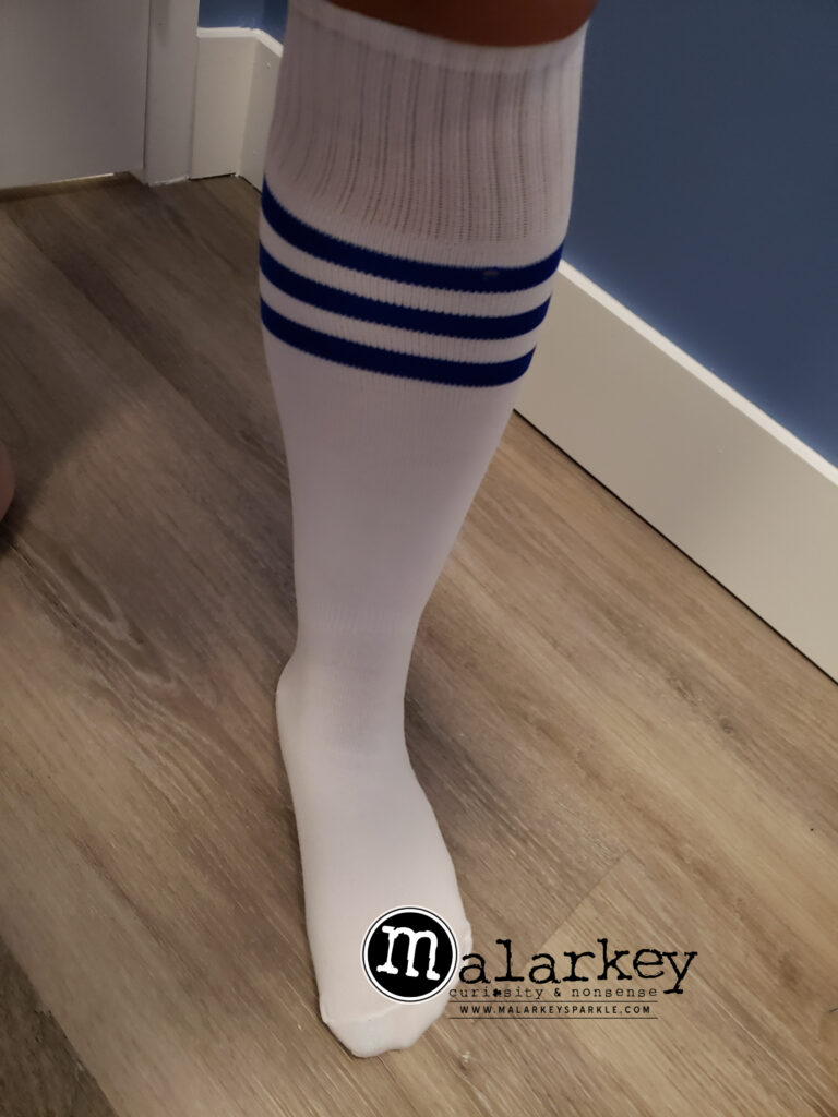 woman leg on the floor knee sox white with blue stripes