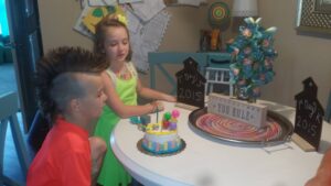 boy with mohawk in front of cake