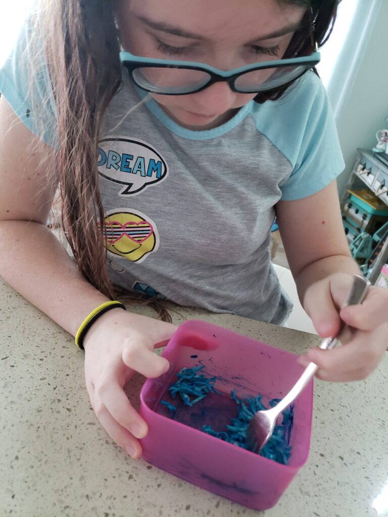 the girl coloring cheese with food coloring
