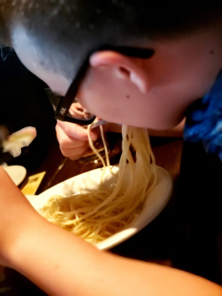 boy eating plain butter pasta