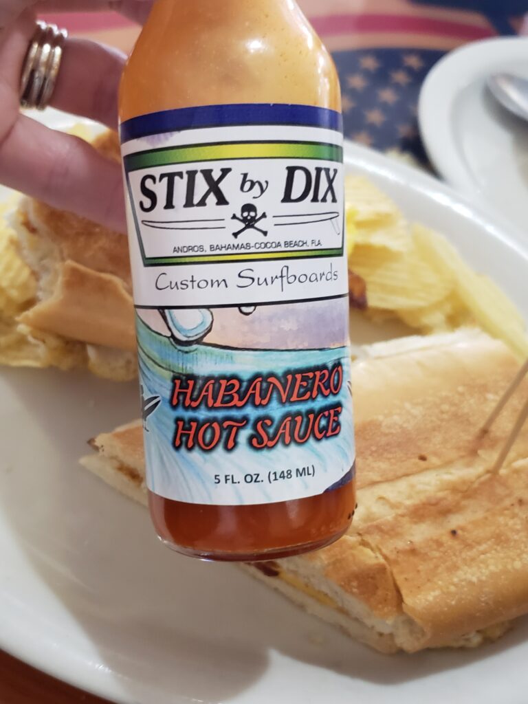 woman holding hot sauce - stix by dix