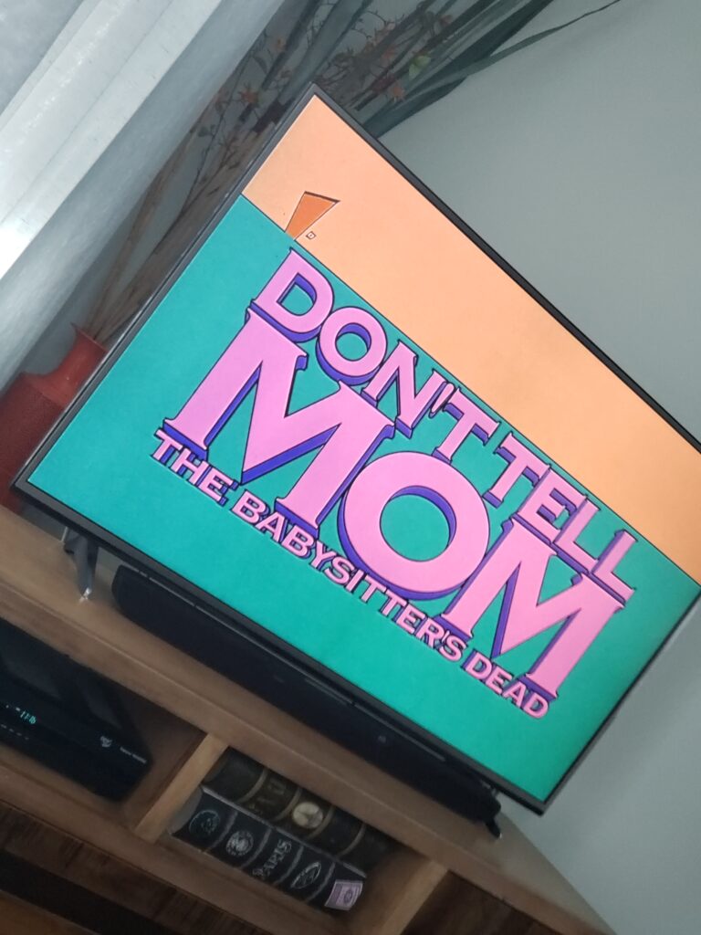 TV SCREEN WITH DONT TELL MOM THE BABYSITTERS DEAD ON THE SCREEN