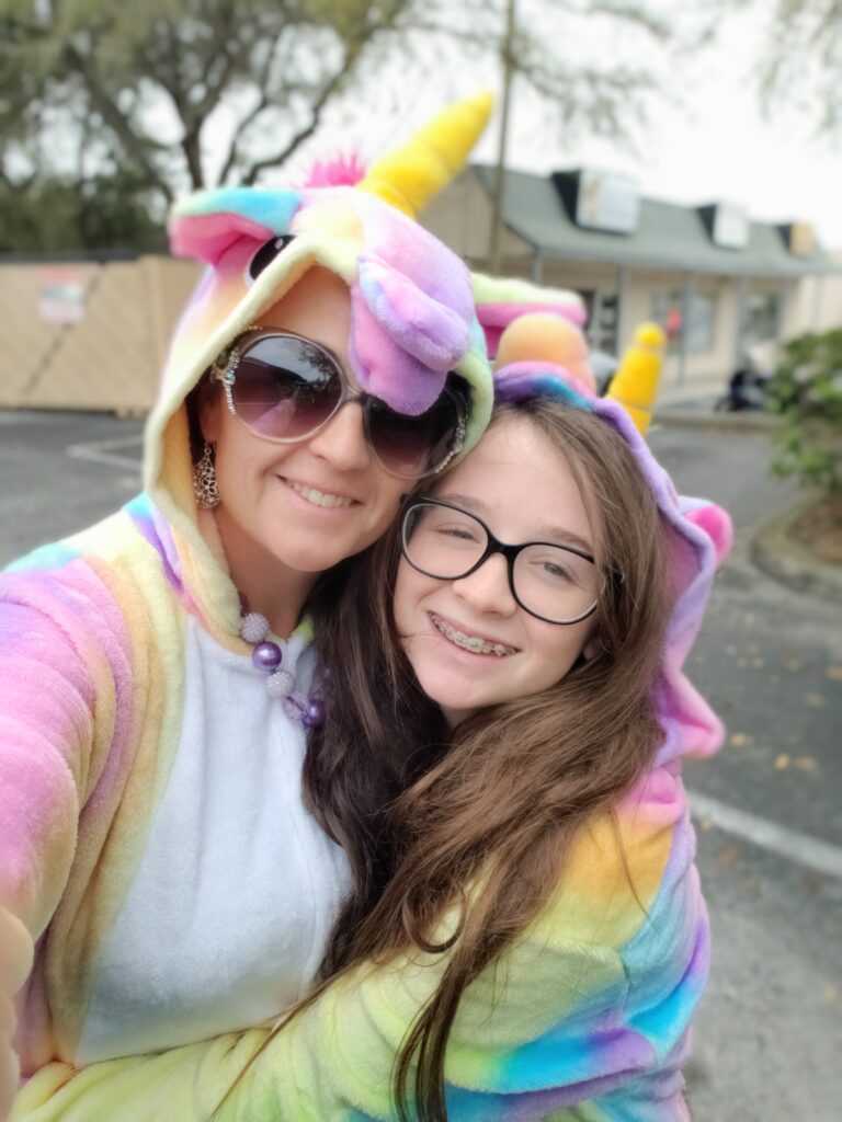 2 girls in unicorn suits and glasses
