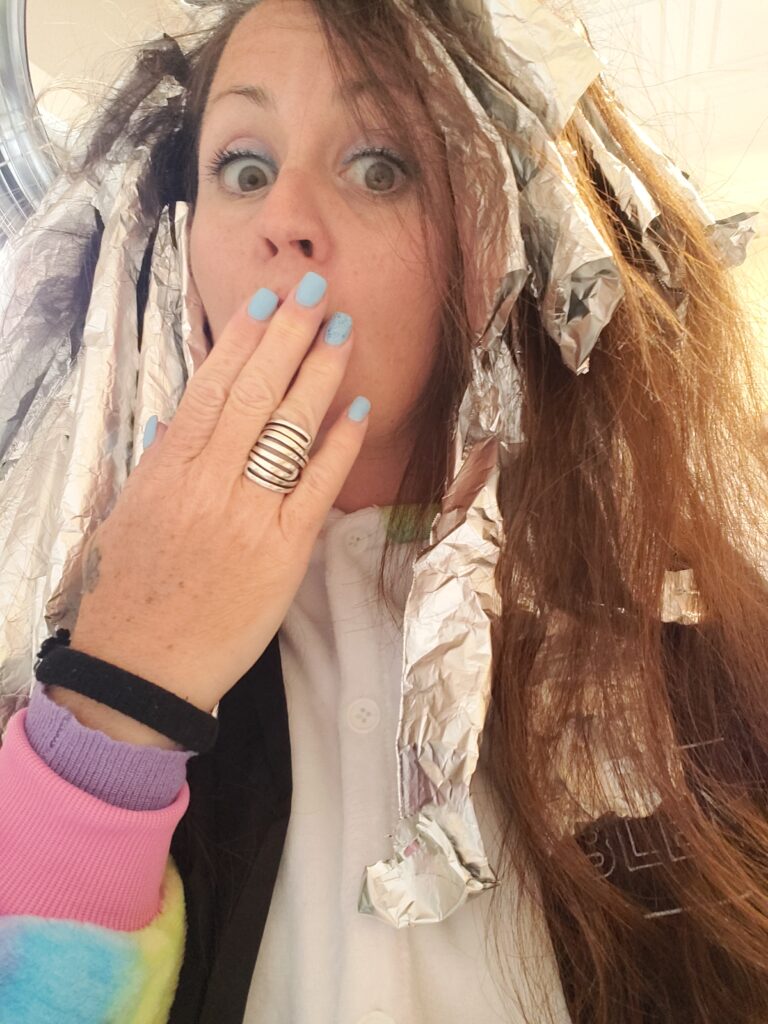 a woman with tinfoil in her hair and unicorn suit
