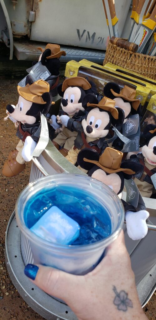 indiana jones swag at a cart in hollywood studios woman holding blue drink