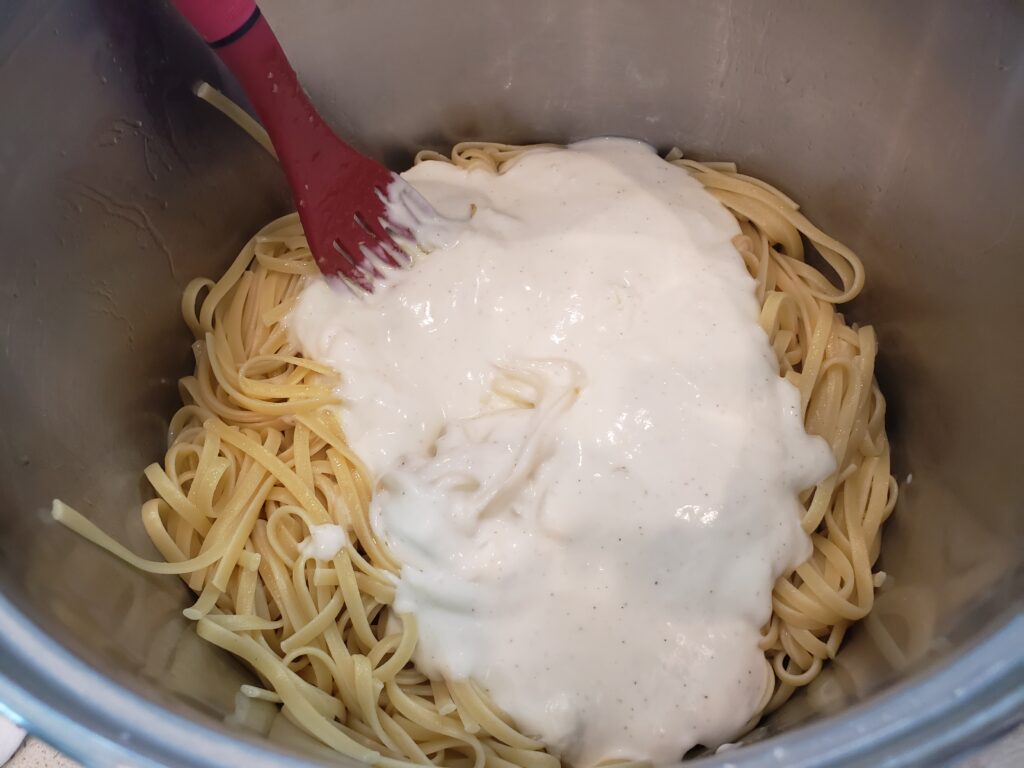 linguine in a pan with sauce on it