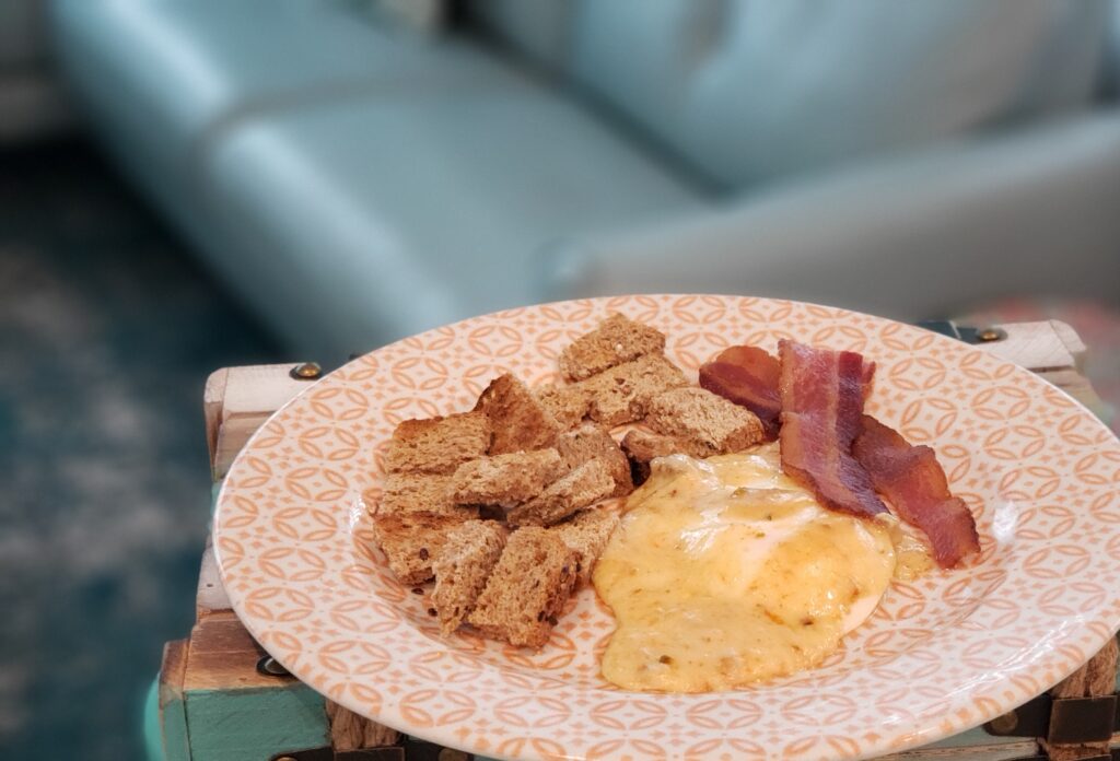 egg, toast, bacon on a plate