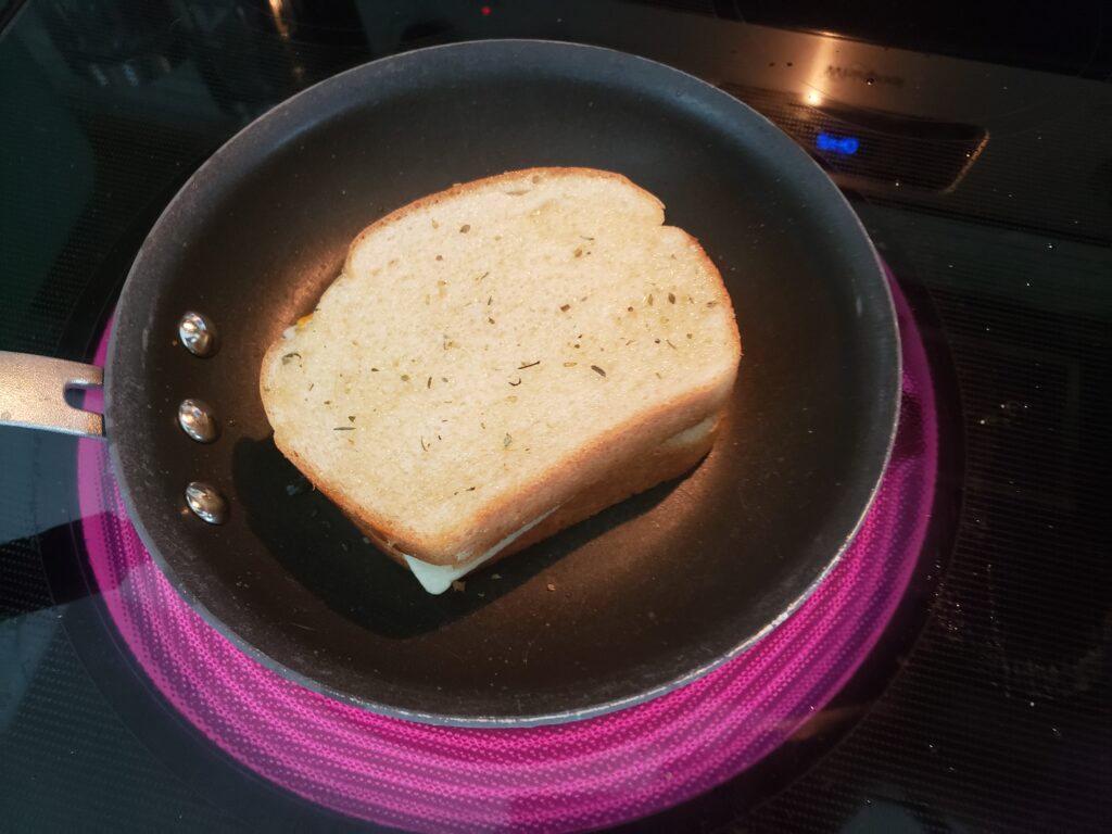 grilled cheese in a pan with spices on top of it