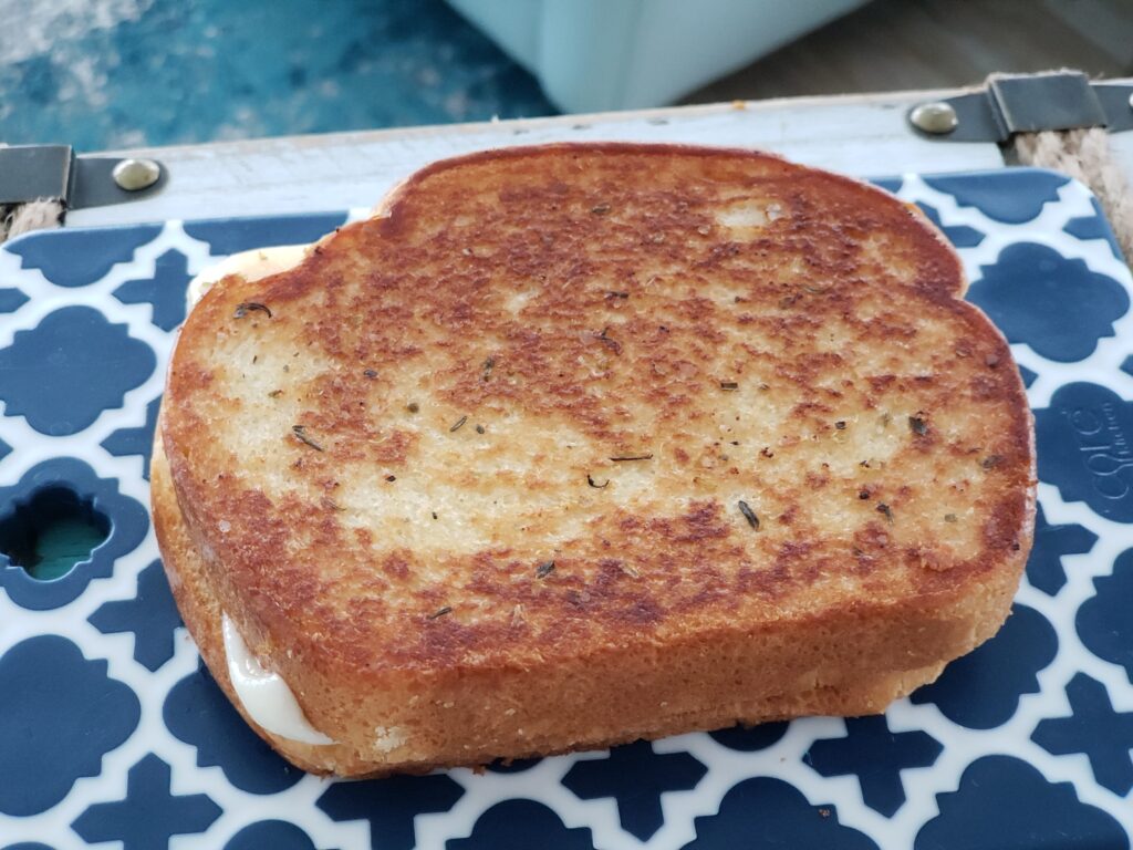 grilled cheese on a blue and white cutting board