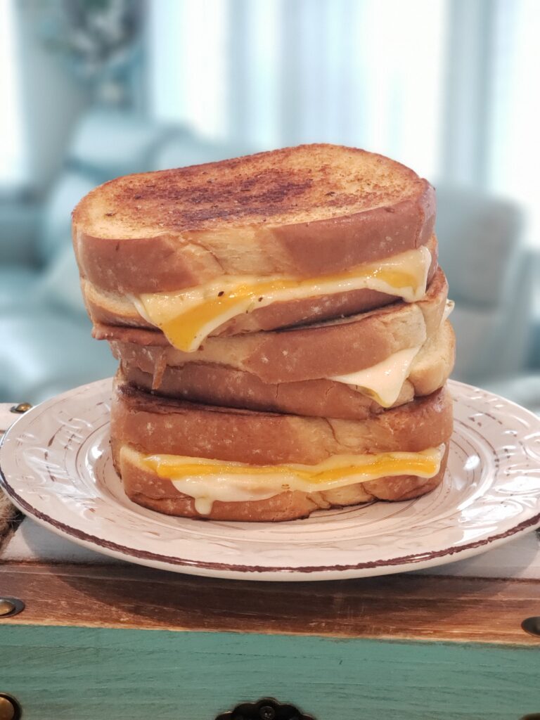 grilled cheese on a white plate - 3 stacked up