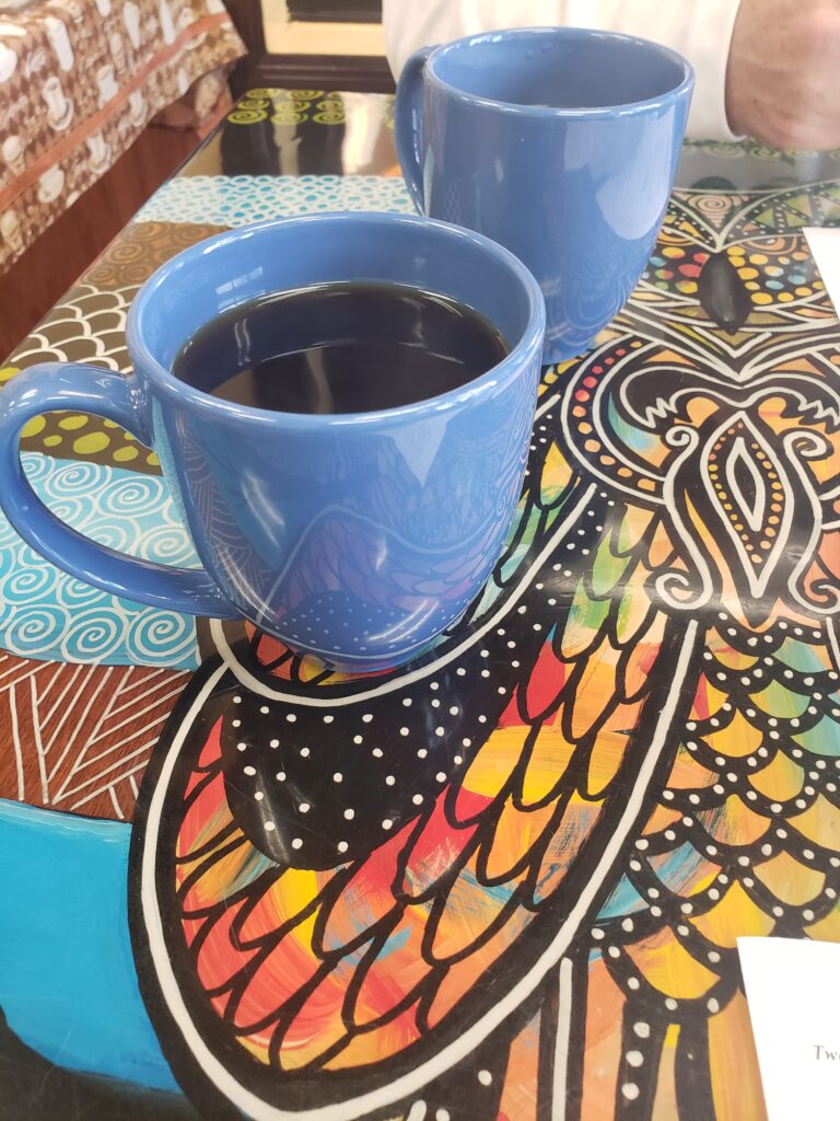 coffee in a blue mug on a colorful table