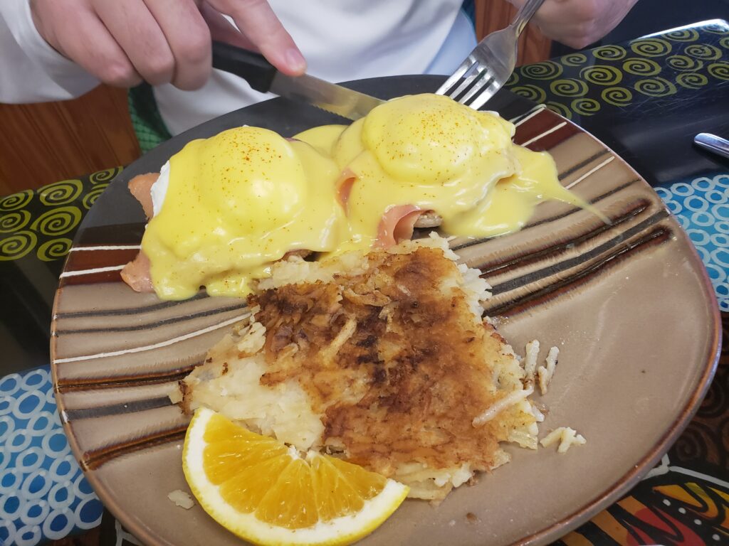 eggs benedict with hasbrown on a plate