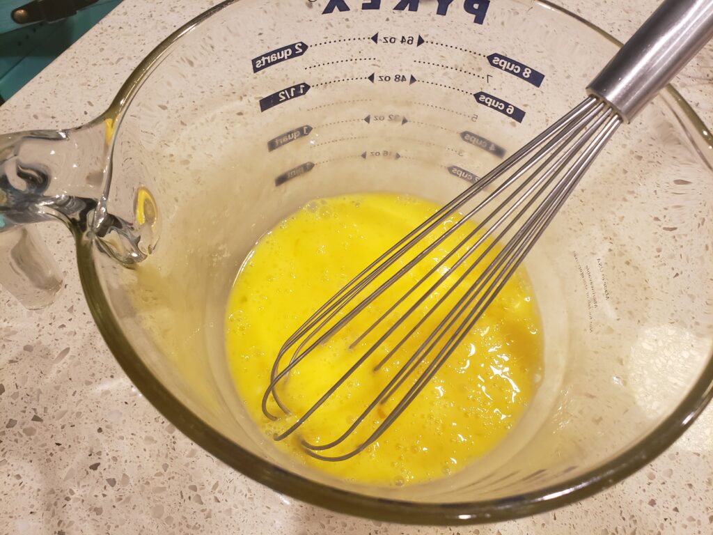 eggs cracked and beaten in a bowl