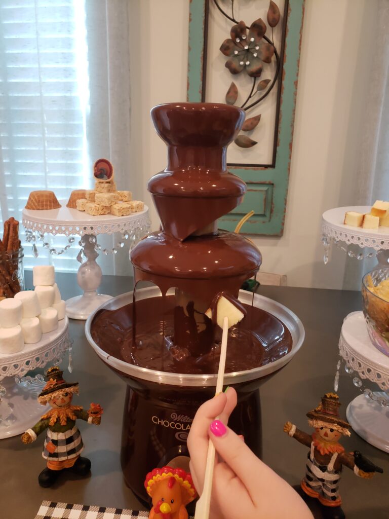pineapple being put into the epic chocolate fountain