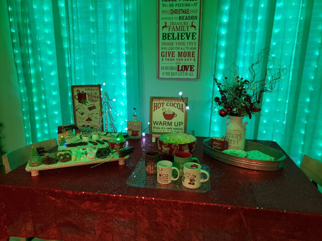 HOT COCOA CHARCUTERIE BOARD - table set up with green lights in the back