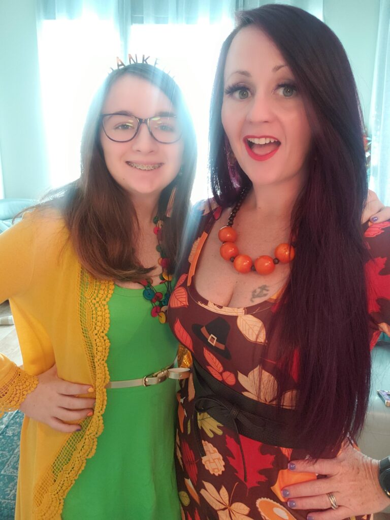 2 girls dressed up and smiling at the camera