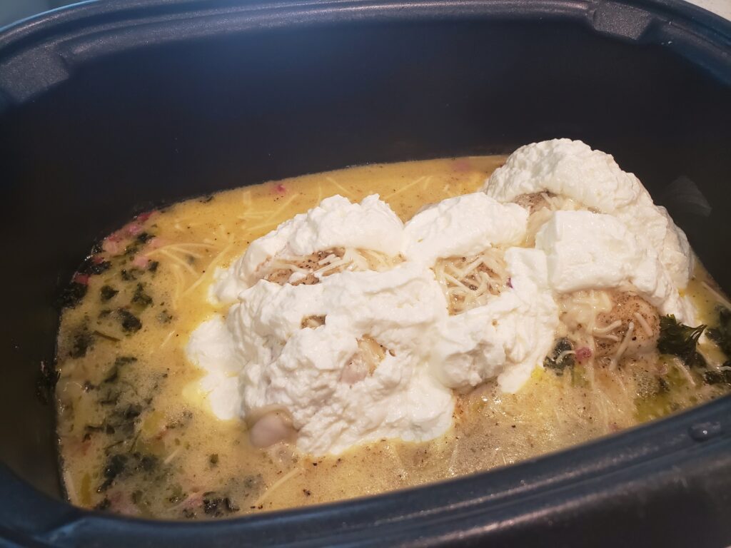 dressing in crockpot with cream cheese on top