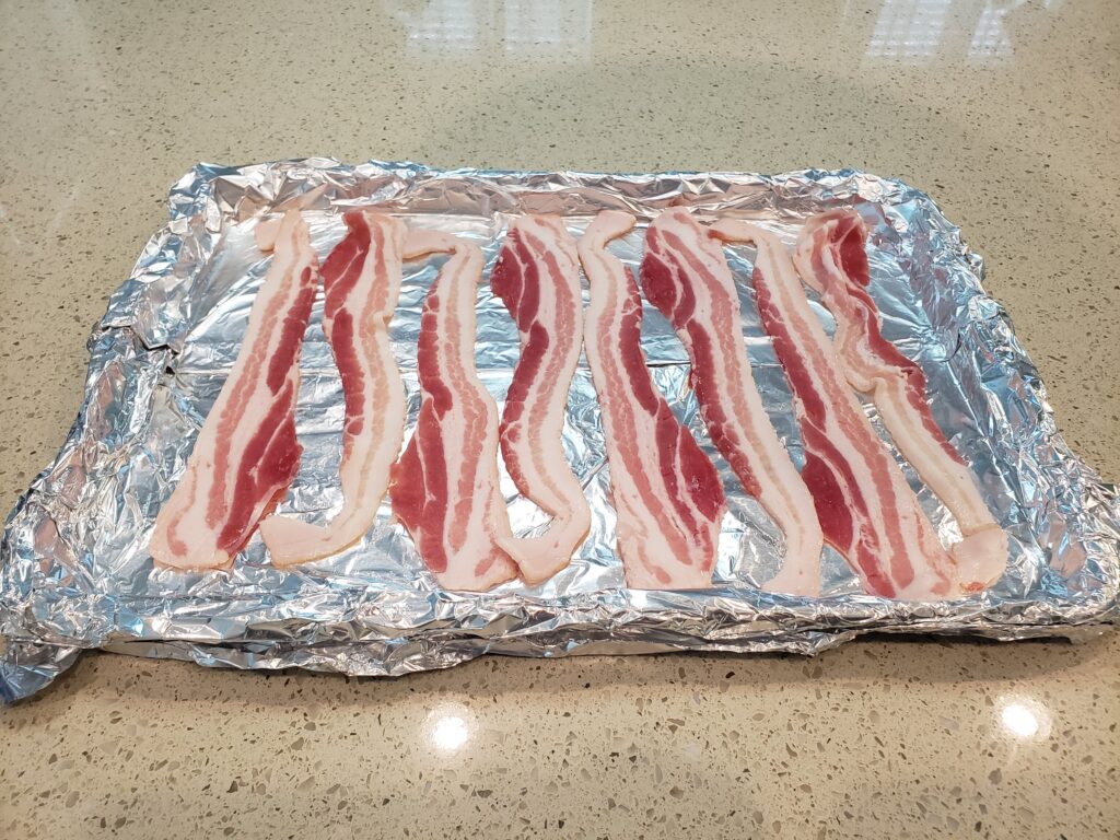 uncooked bacon on a pan