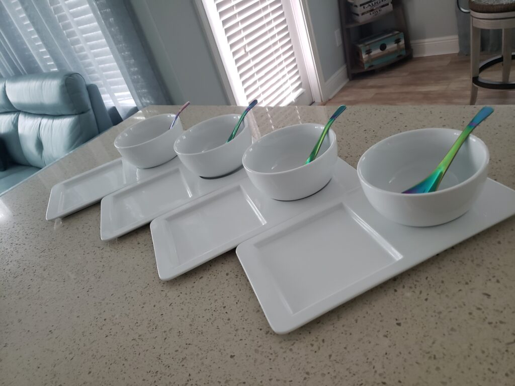 soup dishes on the counter with a spoon in the bowl