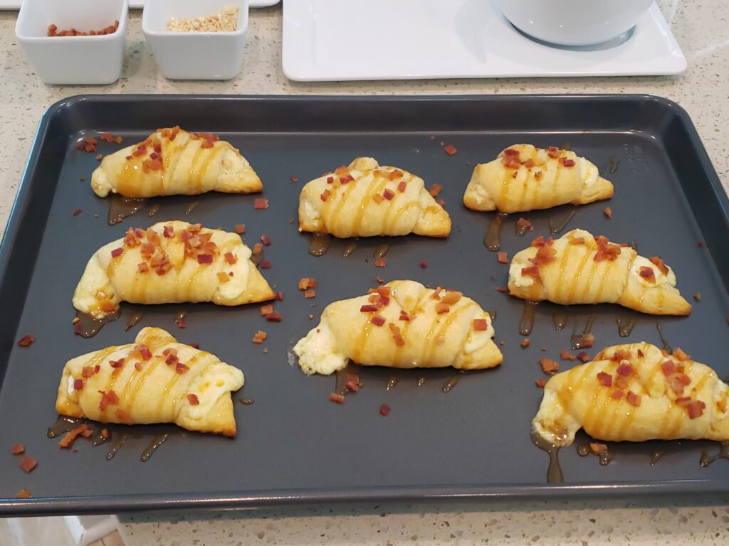 crescent rolls on a pan with caramel and bacon