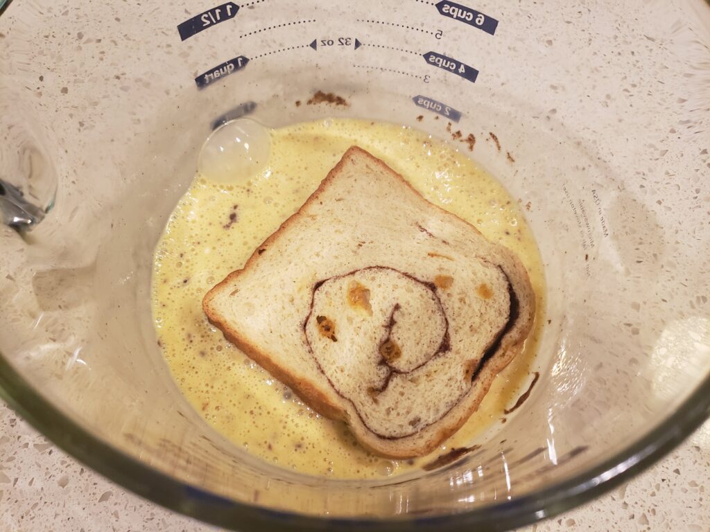 egg batter with pumpkin bread in it