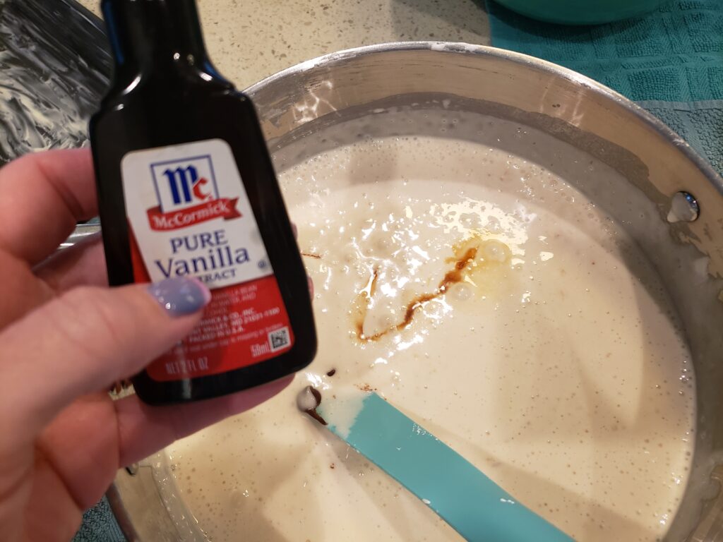 vanilla being poured into the fluff for the fudge - FUDGE - Easy Dark Chocolate Caramel
