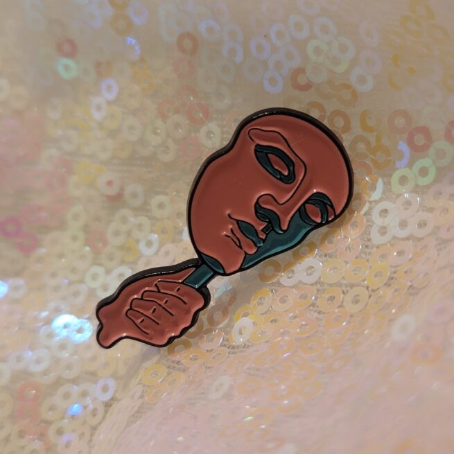 face mask on a stick pin