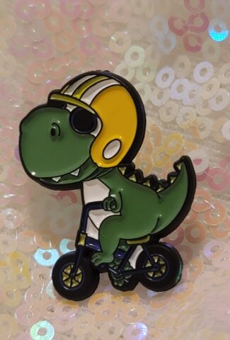 dino on a bike pin