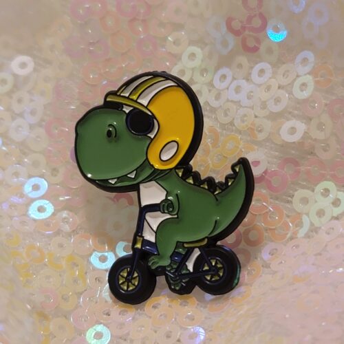 dino on a bike pin