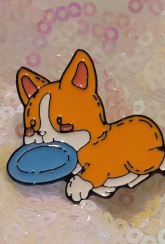 corgi with a frisbee pin
